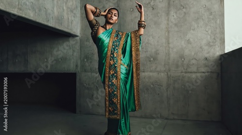 Indian woman in traditional sari posing with hands raised