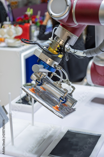 Robotic arms grabbing sheet metal workpieces at exhibition site