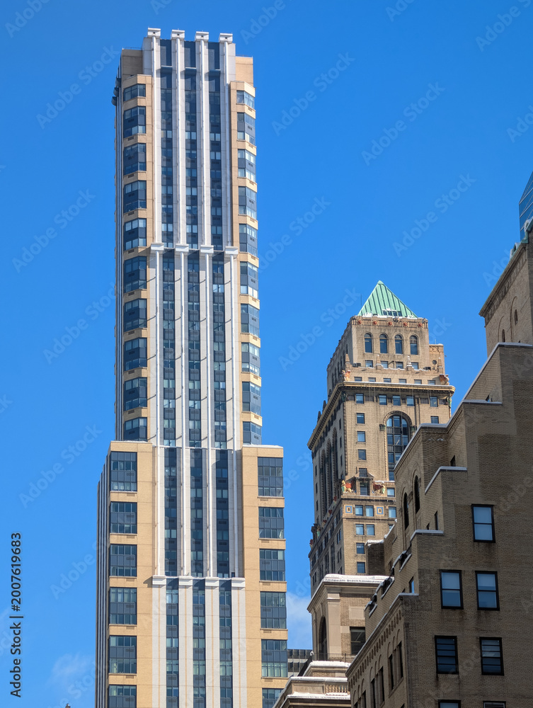Obraz premium Majestic modern New York skyscrapers reflecting sunlight across iconic Manhattan skyline with towering architecture, urban atmosphere, and vibrant city energy, travel Usa