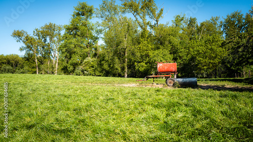 Photos Old manure cart in a spring landscape
