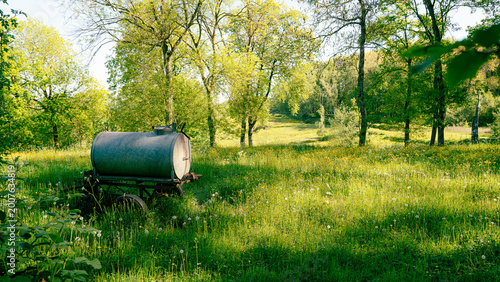 Photos old manure cart in a spring landscape