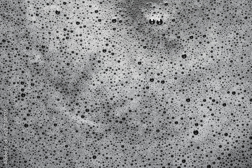 Foam on a dark background. Close-up of the texture of soap foam