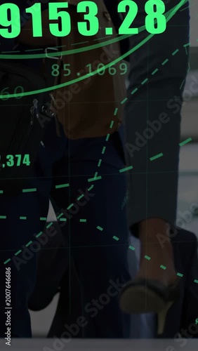 Vertical video: Commuters walking in lobby, camera panning, finance chart floating over shoes, bag