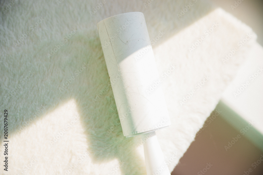 Obraz premium White upholstered furniture surface with sticky cushion. Cleaning of upholstered furniture from dust, wool and hair.