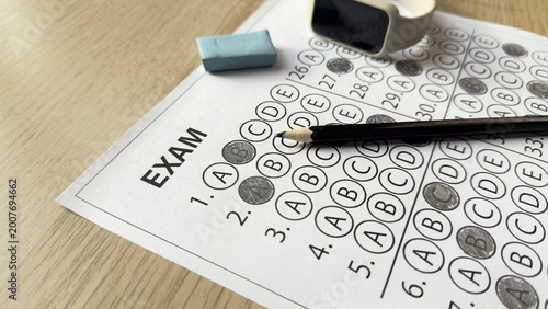 Exam answer sheet with pencil eraser and watch in close view. Concept of time pressure, deadline, testing process, decision making and academic performance