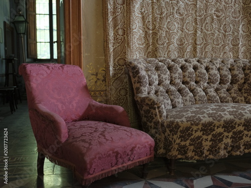 Vintage living room with sofa and armchairs in historic Italian house