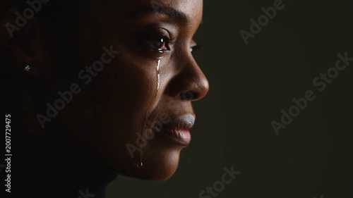 African female sheds tears displaying intense sorrow deep sorrow fills her eyes completely sorrow creates dramatic atmosphere sorrow resonates with audience emotions strongly.