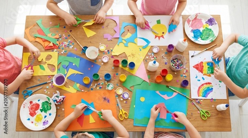 Top-down view of children creating handicrafts.