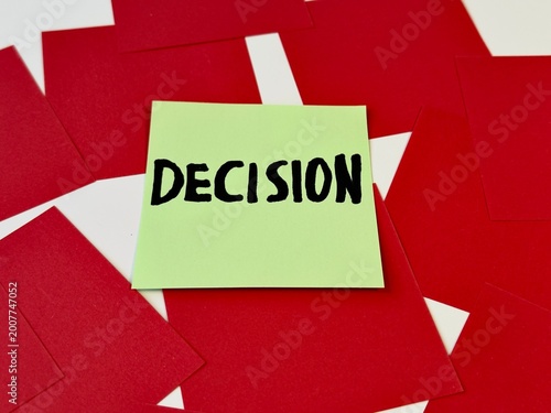 Obraz na plátně Yellow sticky note with word 'DECISION' stands out on red paper background