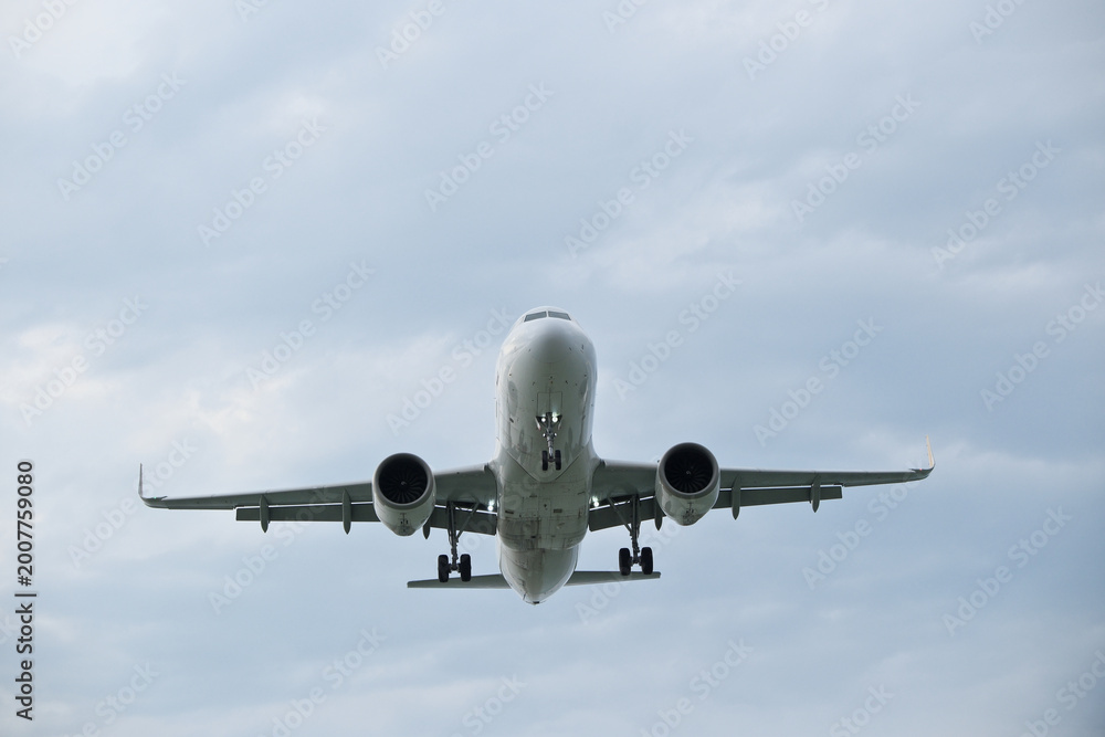 Naklejka premium Commercial White Jet Plane Coming in for Landing, Front View – Air Travel Concept