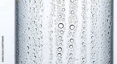 Water droplets on a cold glass bottle surface closeup