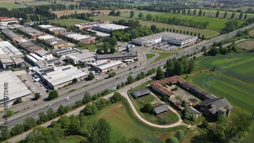 Industrial Landscape: Aerial perspective of an industrial area with modern buildings, roads, and surrounding nature, showcasing the harmony between urban development and the environment. 