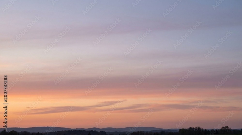 Fototapeta premium Beautiful Sunset Sky with Pastel Pink and Orange Clouds over Hills