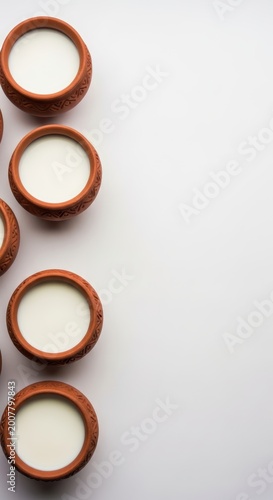 Small clay cups with white liquid.