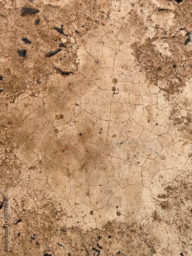 Cracked concrete texture background, dry cement surface with soil stains and weathered ground for grunge design, construction and summer drought concept.