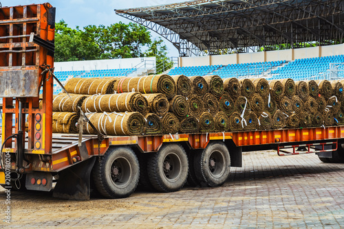 Quadro em tela Truck loaded with sod rolls parked at stadium for lawn landscaping and renovation for football field
