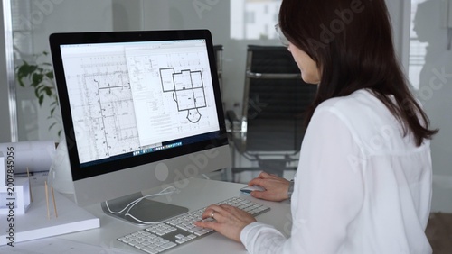 Fotografi Woman architect drawing building plans on computer, designing modern housing project with cad software