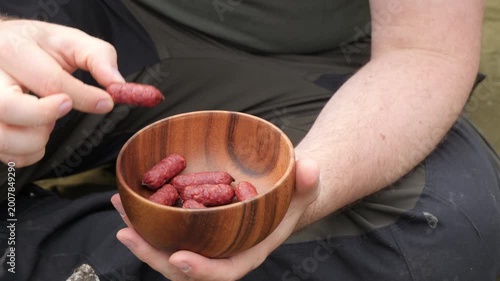 Person Holding Wooden Bowl with Sausages 
