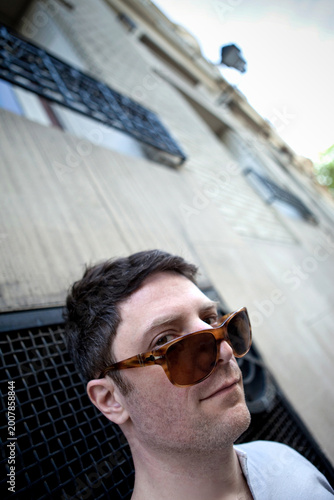 Portrait of a young guy in front of a building