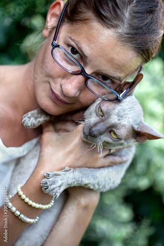 A girl and a cat in the garden