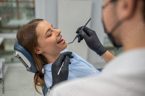 Stomatologist checking teeth with mirror
