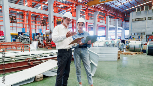Cuadro en lienzo Two Caucasian men meticulously inspect gray concrete floor with metal sheets in metal sheet factory, conducting detailed quality inspection with focused professional mood and safety equipment