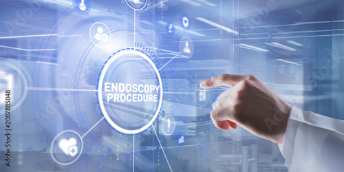 Hand pressing the ENDOSCOPY PROCEDURE button on a digital screen in a medical setting.