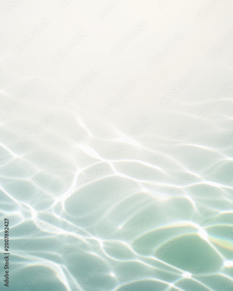 Abstract light blue water ripple surface with caustic light patterns