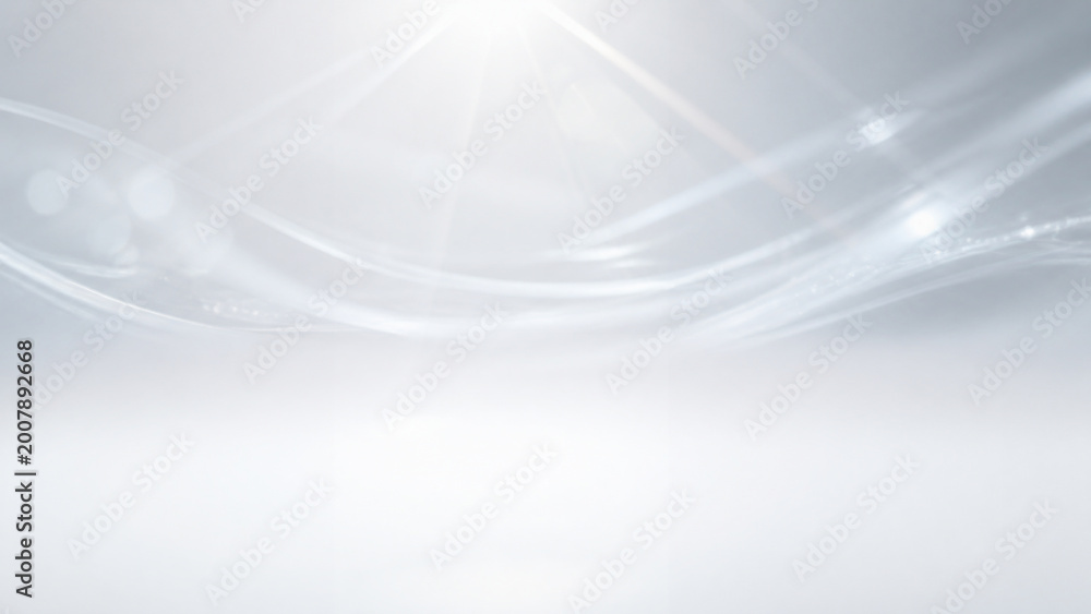 Abstract white and silver flowing lines with bright light effect