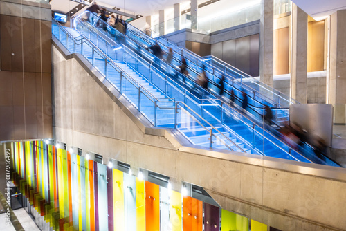People on moving escalators at Sainte-Anne metro subway station in Rennes - France