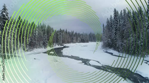 Green rings rotating and expanding, initiating drone descending, revealing open river and ice falls