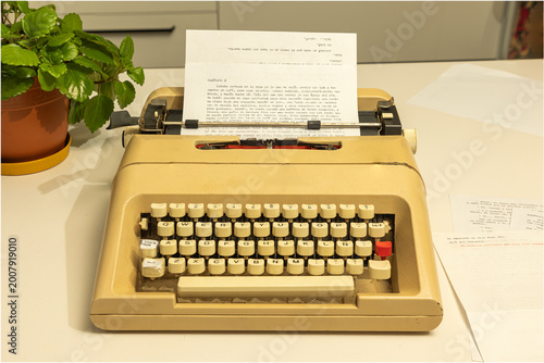 Vintage Typewriter Olivetti Lettera 35 on Writer’s Desk with Paper and Creative Workspace Atmosphere