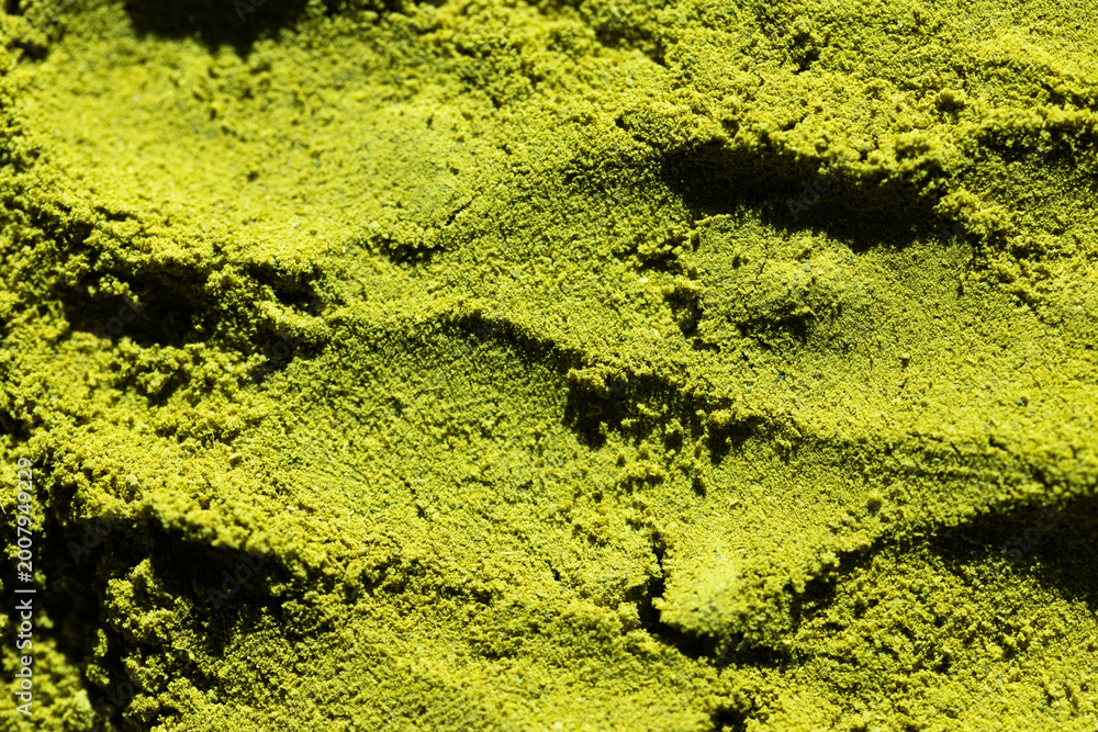 Obraz premium textured surface of green matcha powder natural background perfect for health, food, or branding visuals