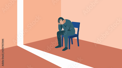 Depressed man sitting alone in a room, light from a door offering hope
