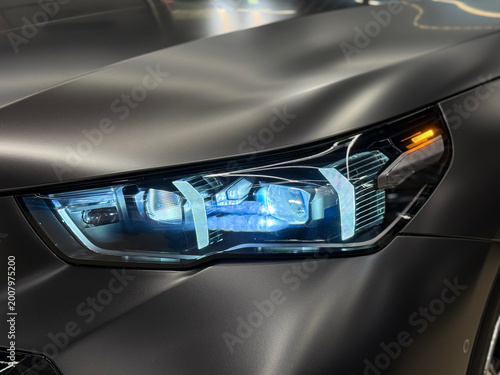 Photos Front BI-LED headlight on a black matte car