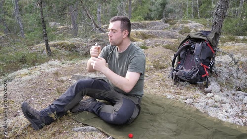 Hiker Drinking While Resting in Forest Camp