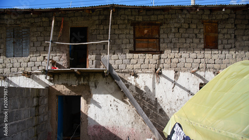 Quadro em tela Traditional rustic adobe house with stone walls in high altitude village