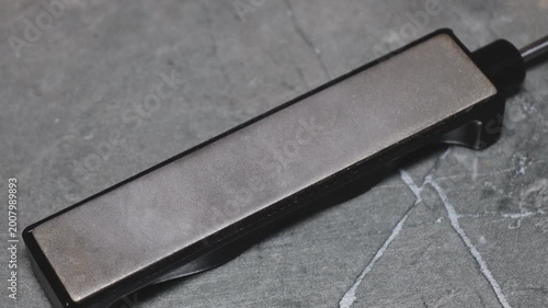 A close-up view of a metallic item on a table, great for use in product photography or as a design element