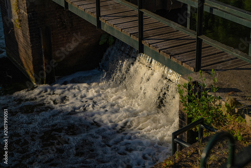 Water Rushing Through Historic Lock Gate in Golden Hour Light, Netherlands