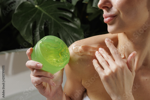Applying Aloe Vera Gel for Skin Care on Beautiful Woman's Shoulder