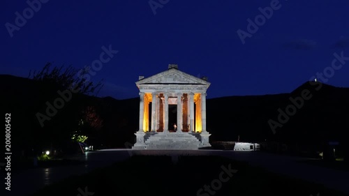 Front view of Garni Temple illuminated at dusk under blue hour sky in Armenia
