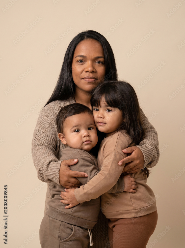 Fototapeta premium Loving mother embracing her two children