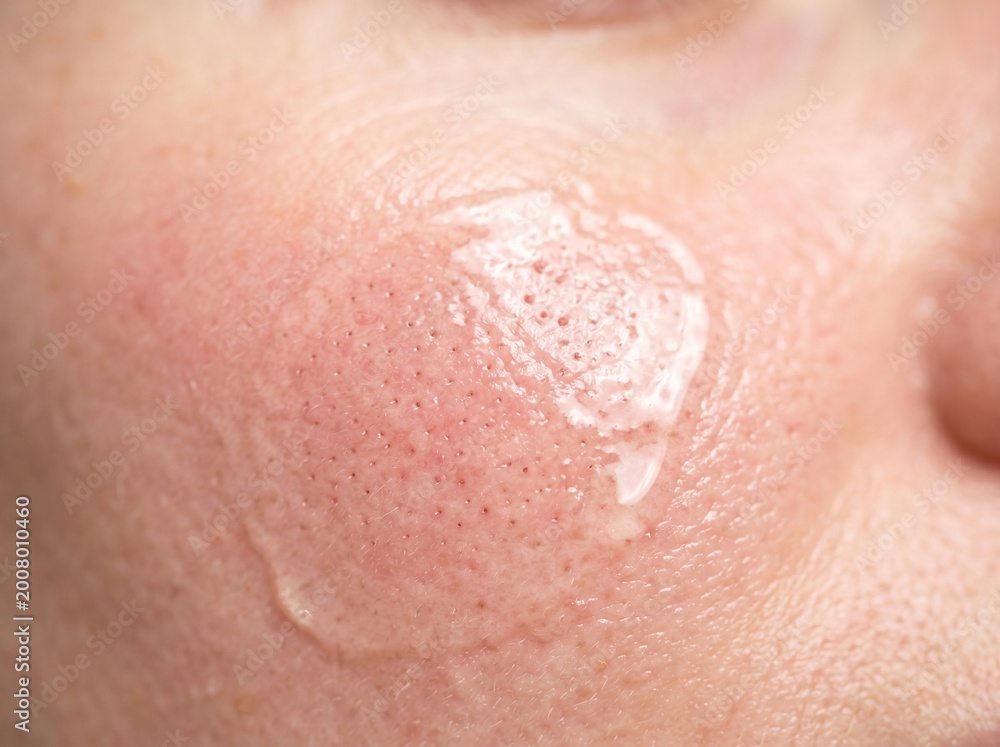 Fototapeta premium Close up of woman's skin with product applied, texture details and pores visible.