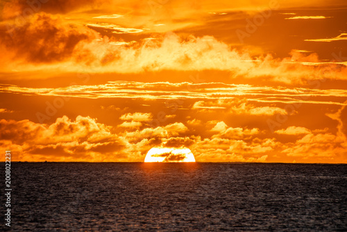 Canvas Print Golden hour, Sunset at ocean, orange sky and clouds