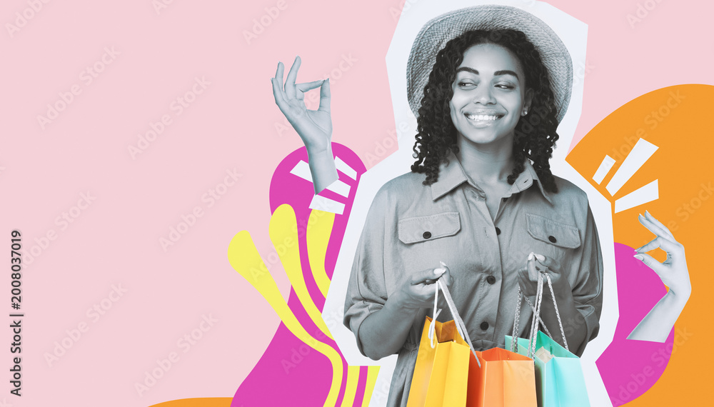 Fototapeta premium A black girl stands in a studio over a pink background holding shopping bags. She smiles while posing, ready for summer sales and enjoying a fun shopping experience with empty space around her.