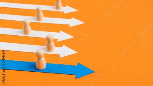 Leadership strategy concept with business direction, success, teamwork, innovation, career growth and competitive advantage shown by wooden figure moving on unique blue arrow path.