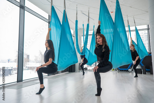 Group yoga class on hammocks. 
