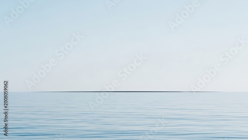 Minimalist seascape with a calm sea and a thin line of land on the horizon.