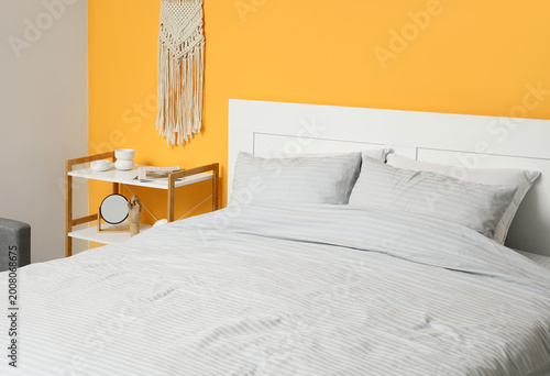 Comfortable bed with grey p...