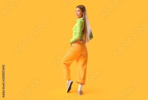 Stylish young woman in snea...